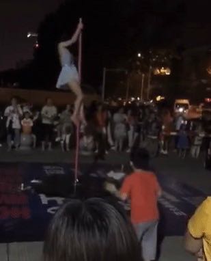 中学门口跳钢管舞，这个舞蹈机构挺别样，真的是选错背景了吗？