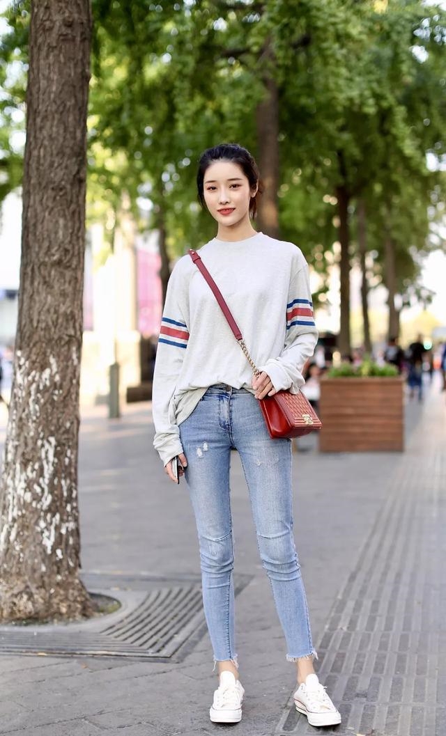 路人街拍，美女浅蓝色牛仔裤搭配休闲上衣，凸显迷人身姿
