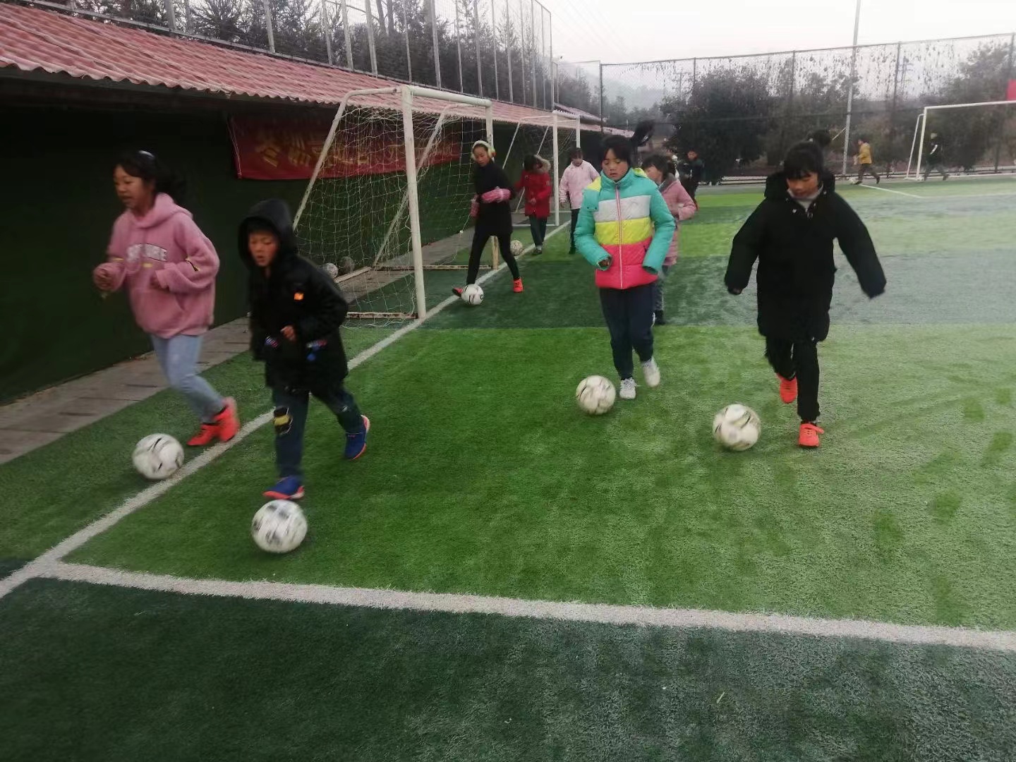 坐在足球里的小女孩(中国女足夺冠后 乌蒙山里的小学生女足球队：长大后我想成为你)