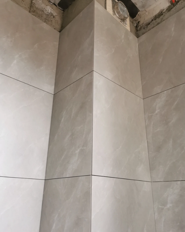 有条件尽量让商家倒角,商家切坏瓷砖损耗算他的,瓦工现场切损耗算你的